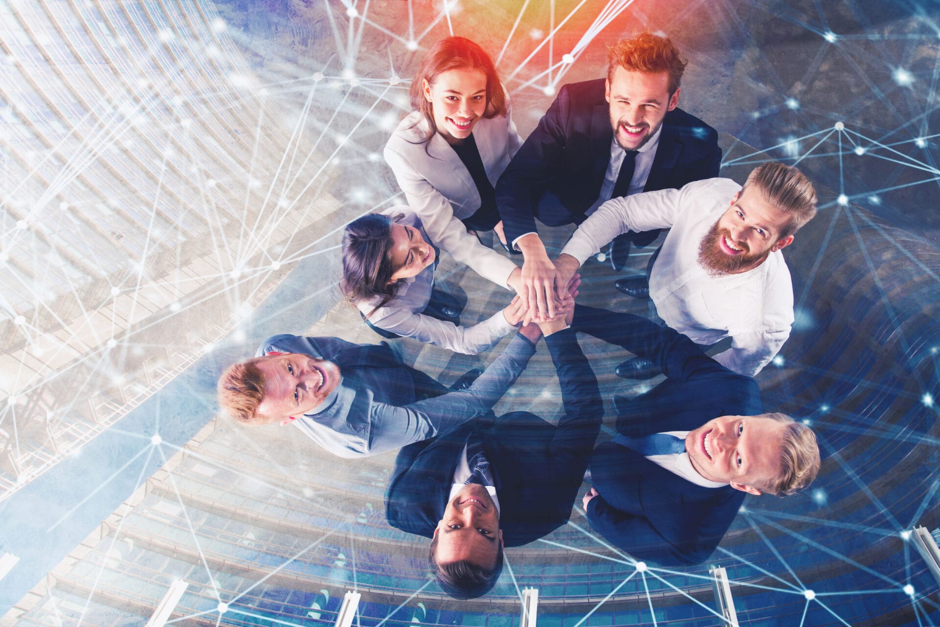 Business people putting their hands together in office with internet network effects. Concept of integration, teamwork and partnership. double exposure